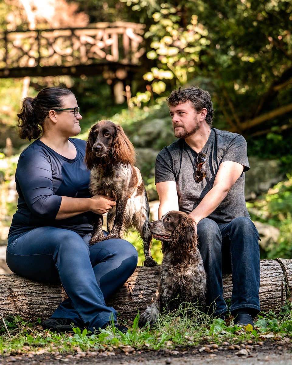 Elina and Tane with Grace and Astra on a log in the woods